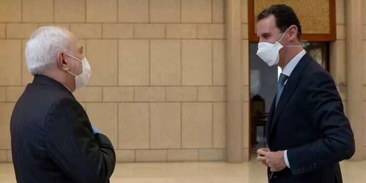 Iranian Foreign Minister Mohammad Javad Zarif and Syrian President Bashar Assad in Damascus, April 20, 2020. Report: Alleged IAF strike near Damascus first since Iran-Syria sign defense pact