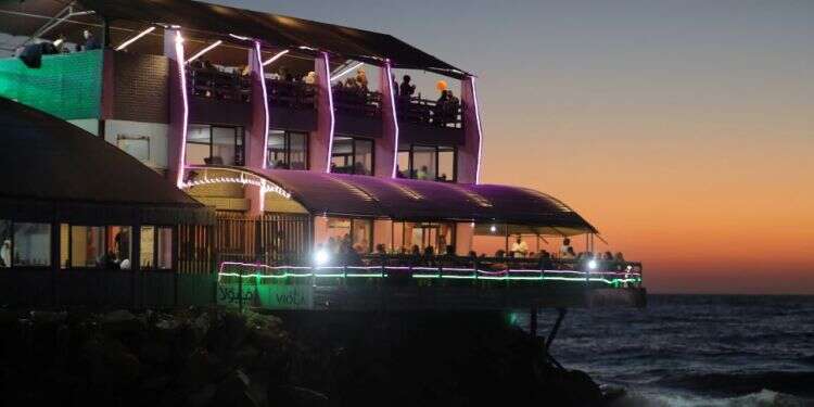 Palestinians leave 'Maldive Gaza' cafe on a beach in Gaza City, Aug. 5 'Dream destination' cafés offer taste of paradise in Gaza