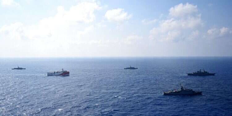 Turkey's research vessel, Oruc Reis, in red and white, is surrounded by Turkish navy vessels in the Mediterranean Sea (Turkish Defense Ministry via AP) Israel stands behind Greece in escalating energy dispute with Turkey