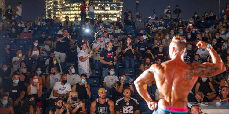 A contestant participates in the final round during the National Amateur Body Builders Association competition in Tel Aviv, Israel, Aug. 19, 2020 Masks, COVID-19 no match for Israeli bodybuilders