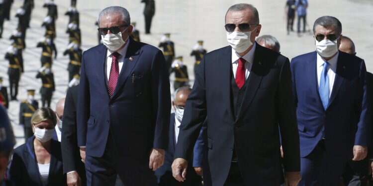 Turkish President Recep Tayyip Erdogan, center, is flanked by Parliament Speaker Mustafa Sentop, left, and Health Minister Fahrettin Koca at the mausoleum of Mustafa Kemal Ataturk, in Ankara, Sunday 'Erdogan is concealing Turkey's true corona figures'