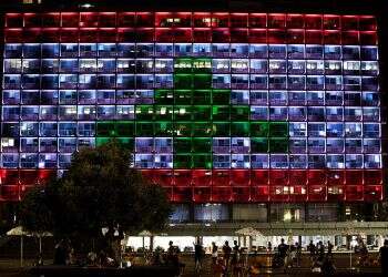 In show of support, Tel Aviv square lights up with colors of Lebanese flag