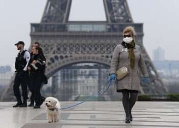A woman near the Eiffel tower during the pandemic in France Eiffel Tower evacuated after bomb threat