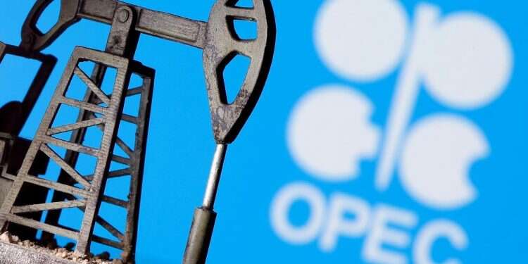 A 3D printed oil pump jack is seen in front of displayed Opec logo Iconic oil cartel OPEC marks 60th anniversary