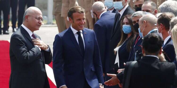 French leader in Baghdad, urges Iraqis to guard sovereignty