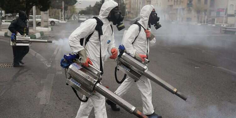 Iranian firefighters disinfect public areas Middle East COVID death toll passes 50,000