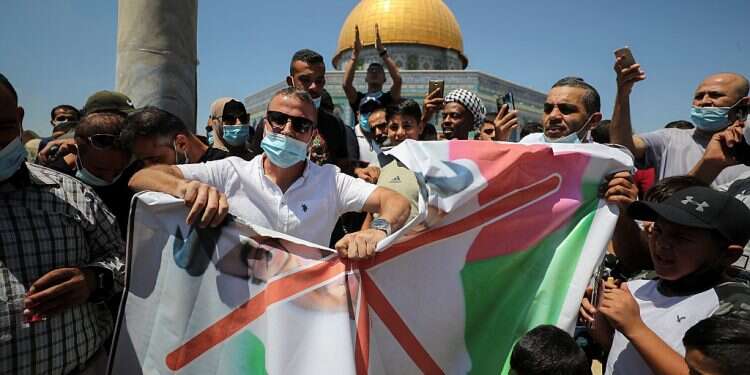 Pro-Palestinian protesters tear a picture depicting Abu Dhabi Crown Prince Mohammed bin Zayed al-Nahyan during a protest against the United Arab Emirates Palestinians fail to persuade Arab ministers to condemn UAE-Israel deal