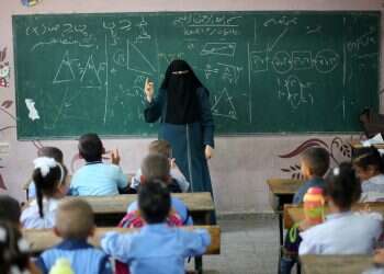 A Palestinian teacher gives a math lesson at a UN-run school, in Khan Yunis, Gaza 'PA's textbooks openly anti-Semitic despite revision promise'