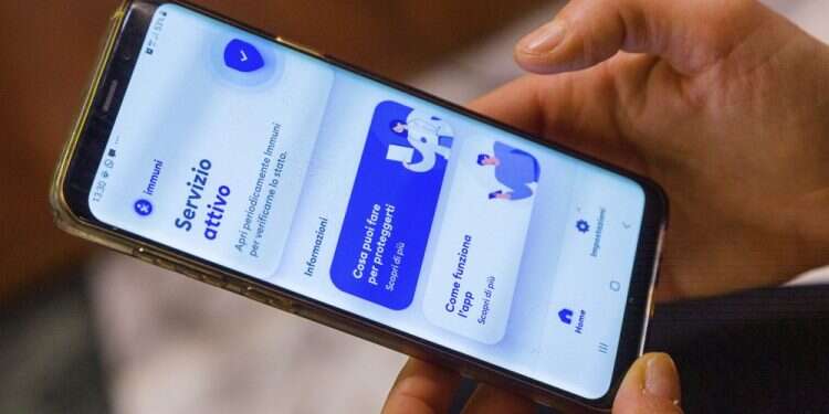 Italian Technological Innovation and Digitalization Minister Paola Pisano shows her phone, featuring a contact tracing app that Italy launched nationwide in its efforts to contain COVID-19's spread EU to link COVID-19 tracing apps together