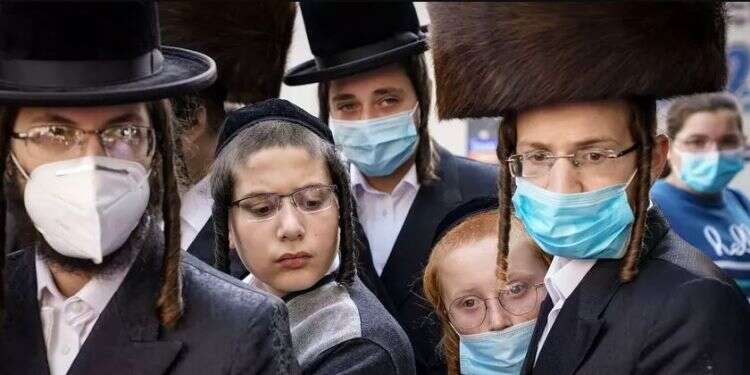 Members of the Orthodox Jewish community mostly wearing protective masks amid the coronavirus pandemic in the Borough Park neighborhood of the Brooklyn borough of New York NY Gov. Cuomo bans Satmar wedding expected to draw 10,000