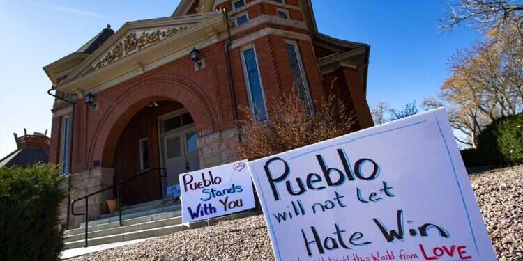 In this July 25, 2020, file photo, signs, flowers and candles expressing love for the Jewish community are placed outside the Temple Emanuel in Pueblo, Colo. Would-be synagogue bomber pleads guilty