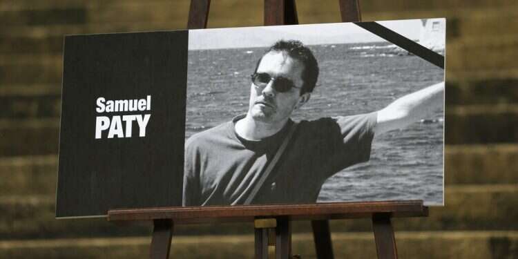 A portrait of slain teacher Samuel Paty with a black ribbon is displayed Tuesday, Oct. 20, 2020 on the steps of the National Assembly in Paris After beheading, France to ban pro-Hamas group in war on Islamist 'separatism'