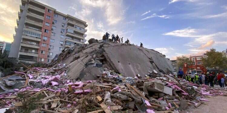 Rescue workers try to save people trapped in the debris of a collapsed building, in Izmir, Turkey, Oct. 30, 2020 Israel offers to send top IDF rescue team to Turkey after deadly quake