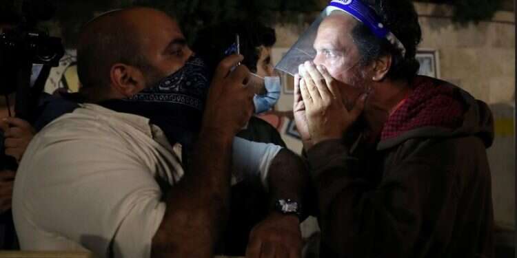 Protesters argue during a demonstration in Jerusalem, Oct. 3, 2020 38 arrested as protests against PM persist despite lockdown