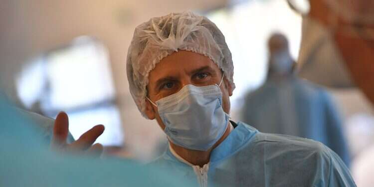 French President Emmanuel Macron wearing protective suit and face mask visits the Kolmi-Hopen protective face masks factory in Saint-Barthelemy-d'Anjou, in central France France becomes first European country to top 2 million COVID cases