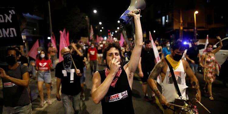 Anti-PM demonstrator compares Netanyahu to Hitler