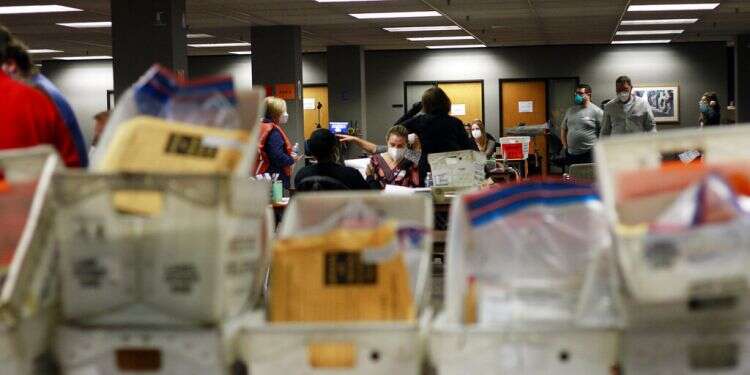 Election workers count absentee ballots into the early morning, Wednesday, Nov. 4, 2020 in Milwaukee, Wisconsin Tight presidential race sees US face electoral limbo