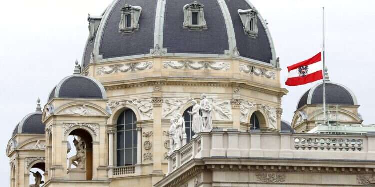 The Austrian national flag waves half-mast on a building in downtown in Vienna, Austria, Wednesday, Nov. 4 Austria plans intelligence agency reforms after Vienna attack