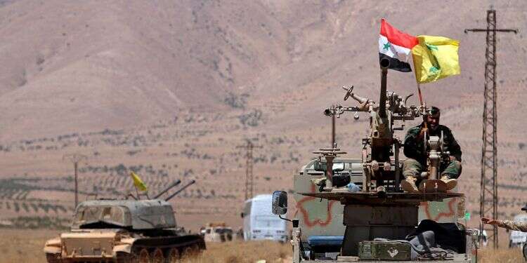Hezbollah and Syrian flags flutter on a military vehicle in Western Qalamoun, Syria in 2017 New report sheds light on true scope of Hezbollah's presence in southern Syria