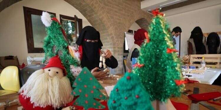 A Palestinian woman works on a Christmas-themed doll in a handicraft workshop, in the northern Gaza Strip, Dec. 1, 2020 A gloomy Christmas in store for Gaza handicraft workshop