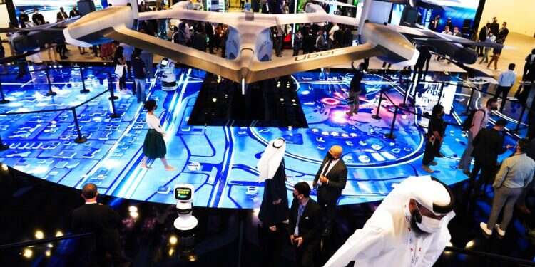 People visit an exhibit at the GITEX technology summit in Dubai, United Arab Emirates, Dec. 7, 2020 In first, 200 Israeli companies take part in major tech expo in Dubai