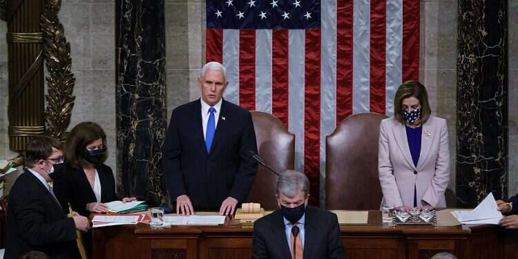 Speaker of the House Nancy Pelosi and Vice President Mike Pence talk before a joint session of the House and Senate convenes to count the Electoral College votes, Jan. 6, 2021 (AP/J. Scott Applewhite) Reeling from Capitol riots, Congress affirms Biden's Electoral College victory