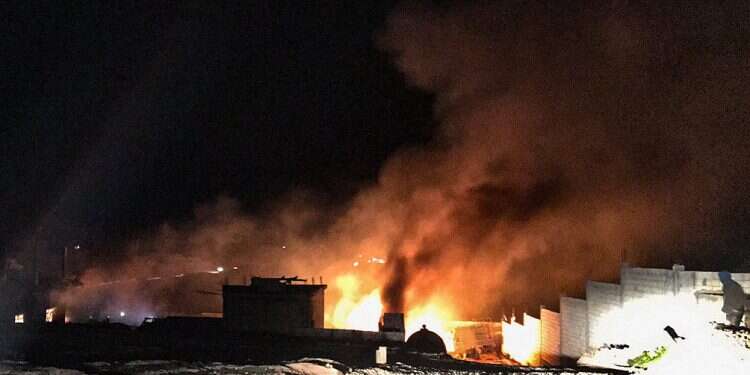 Fire and smoke rise over the scene of an explosion in the eastern Bekaa valley, near the Syrian border, Jan. 3, 2021 Report: Several hurt in warehouse blast near Syria border