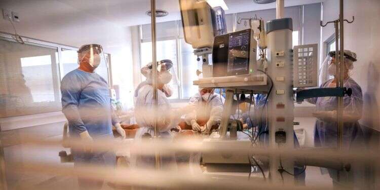 As vaccine drive gains speed, hospitals are overrun with COVID patients