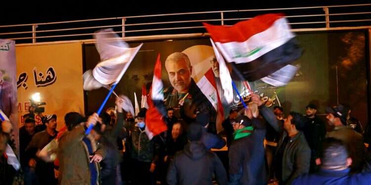 Popular Mobilization Forces and their supporters chant slogans against the United States at Baghdad's international airport on the anniversary of the killing of Abu Mahdi al-Muhandis, deputy commander of the PMF and Gen. Qasem Soleimani, head of Iran's Quds forces, Saturday, Jan. 2 Iraqis rally to commemorate 1-year anniversary of Soleimani's killing
