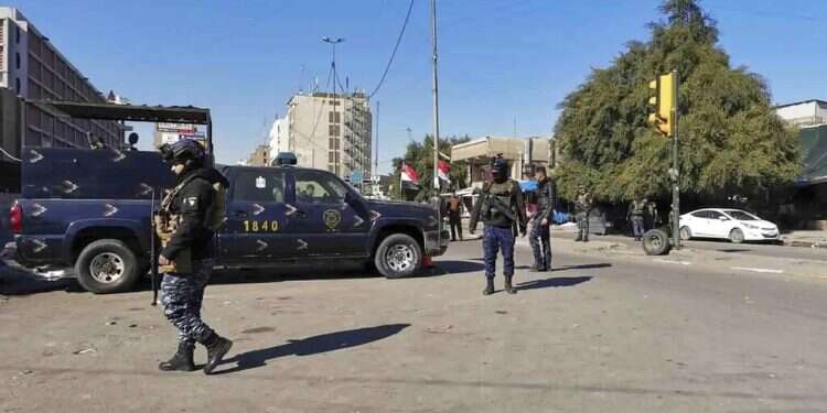 Security forces gather at the site of a deadly bomb attack in Baghdad's bustling commercial area, Iraq, Thursday, Jan. 21 Twin suicide bombings in Baghdad leave at least 13 dead