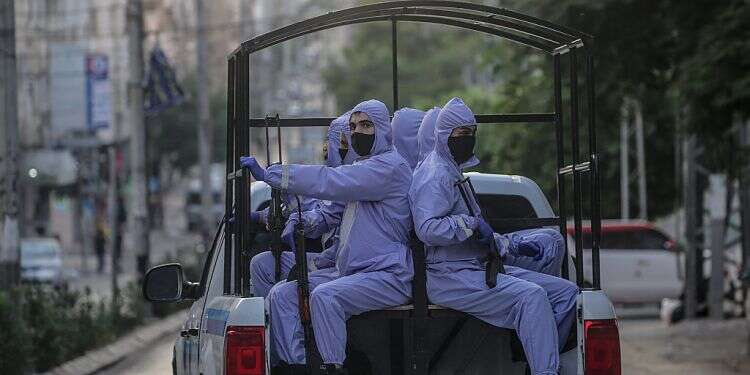 Hamas security wear a protective gear patrol in the streets amid the ongoing coronavirus COVID-19 pandemic in Gaza City, Sept. 1, 2020 Israel allows COVID vaccines into Hamas-run Gaza