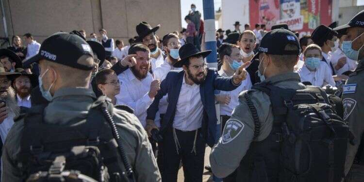 ltra-Orthodox Jews argue with Israeli border police officers during a protest over the coronavirus lockdown restrictions, in Ashdod, Jan. 24, 2021 Israel's ultra-Orthodox defy virus rules, reject criticism