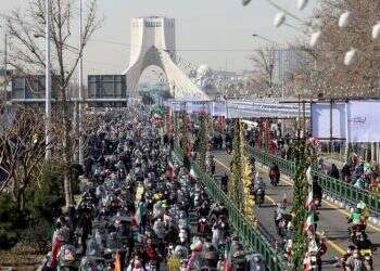 Socially-distanced Iranians parade on wheels to mark 1979 Revolution