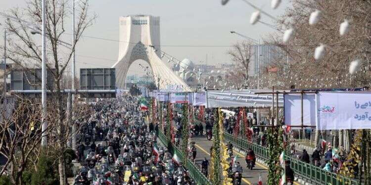 Iranians ride on motorcycles as they participate in the celebration of the 42nd anniversary of the Islamic Revolution in Tehran, Feb. 10, 2021 Socially-distanced Iranians parade on wheels to mark 1979 Revolution