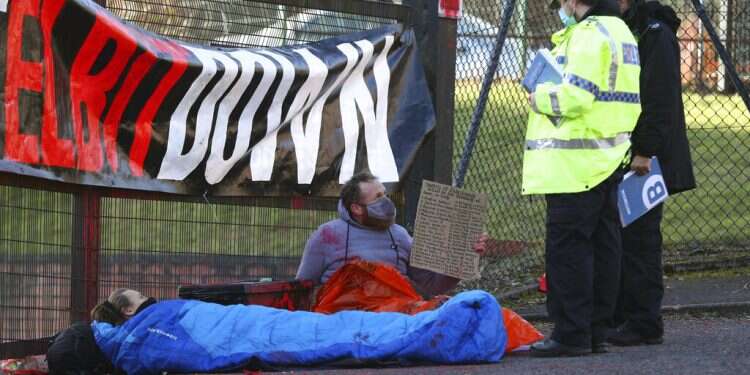 Police talk to protesters blocking the entrance to Israeli-owned Elbit Ferranti arms company in Oldham, Greater Manchester, England, Monday, Feb. 1 Pro-Palestinian activists in UK chain themselves to gates of Elbit factory