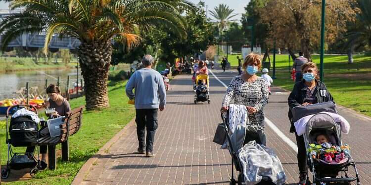 Israelis wear masks while enjoying the sun in Yarkon Park in Tel Aviv, Sunday Israel sees drop in number of seriously ill COVID patients
