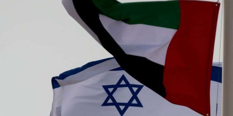 Emirati and Israeli flags fly upon the arrival of Israeli and US delegates at Abu Dhabi International Airport on Aug. 31, 2020 Citing air travel curbs, Israel cancels participation in UAE defense expo