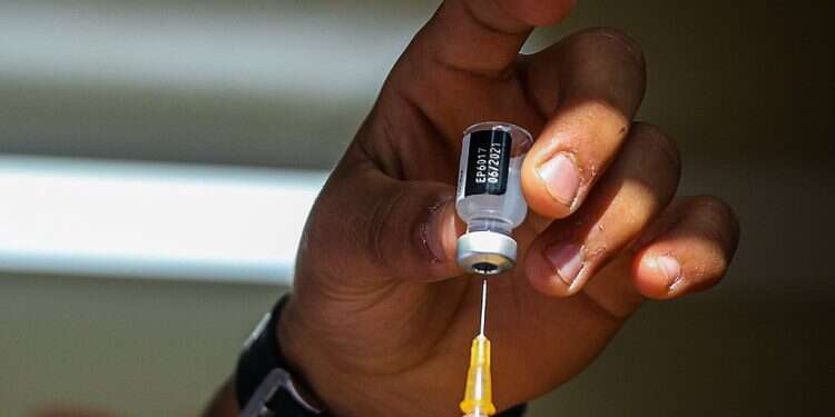 A medical worker prepares a dose of the COVID vaccine at Mahane Yehuda market in Jerusalem, Feb. 24, 2021 Legal difficulties and common sense