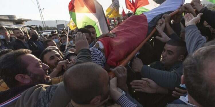 Palestinian mourners chant anti-Israel slogans while carrying the body of Atef Hanaisheh, 45 during his funeral east of Nablus, Friday, March 19 Palestinians say West Bank protester killed by Israeli fire