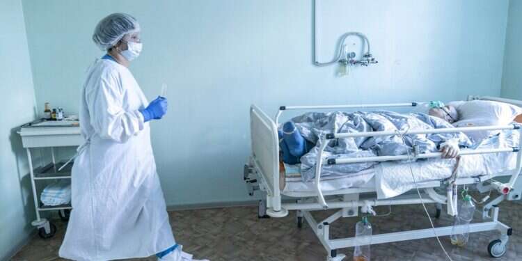 A nurse in COVID protective gear treats a patient at the intensive care unit at a hospital in the mining town of Selydove, 700 kilometers (420 miles) east of Kyiv, eastern Ukraine, March 4, 2021 EU gets more Pfizer vaccines to target hard-hit borders