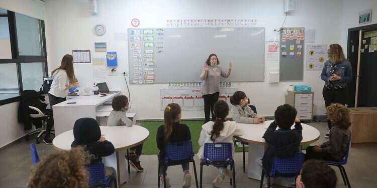 Kids return to the classroom at Yitzhak Navon Elementary School in Herzliya after Israel's third lockdown ends, Feb. 11, 2021 'Within a month, schools will be fully back on track'