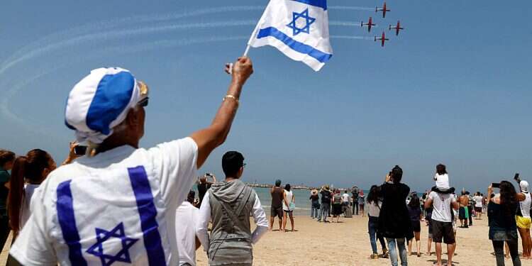 Israelis watch planes perform over Tel Aviv during celebrations marking Israel's 73rd Independence Day