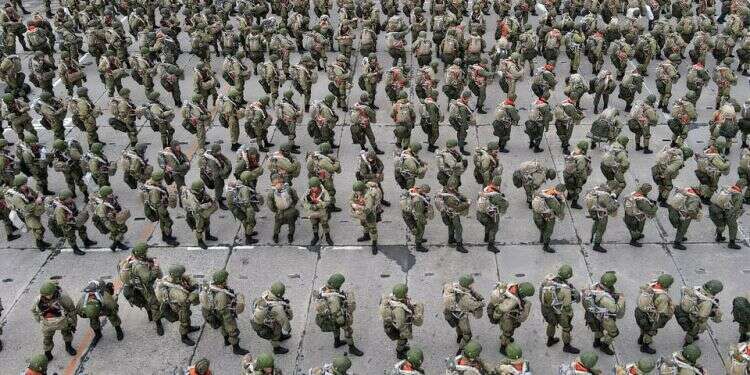 Service members of the Russian airborne forces line up before boarding Ilyushin Il-76 transport planes during drills at a military aerodrome in the Azov Sea port of Taganrog, Russia on April 22, 2021 Russia orders soldiers to begin return to bases after drills near Ukraine