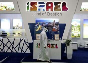 A man passes by the Israel booth on the opening day of the Arabian Travel Market exhibition, in Dubai, United Arab Emirates, May 16, 2021 A tough sell: In Dubai amid Gaza hostilities, Israel promotes tourism