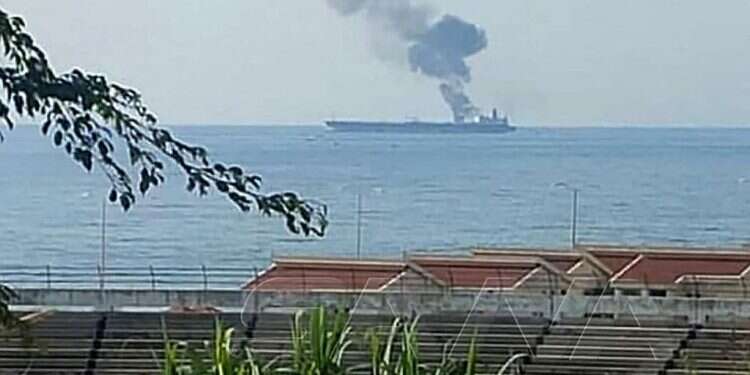 Smoke billows from a tanker off the coast of the western Syrian city of Baniyas on April 21, 2021 Damascus accuses Israel of attacking oil tankers headed for Syria