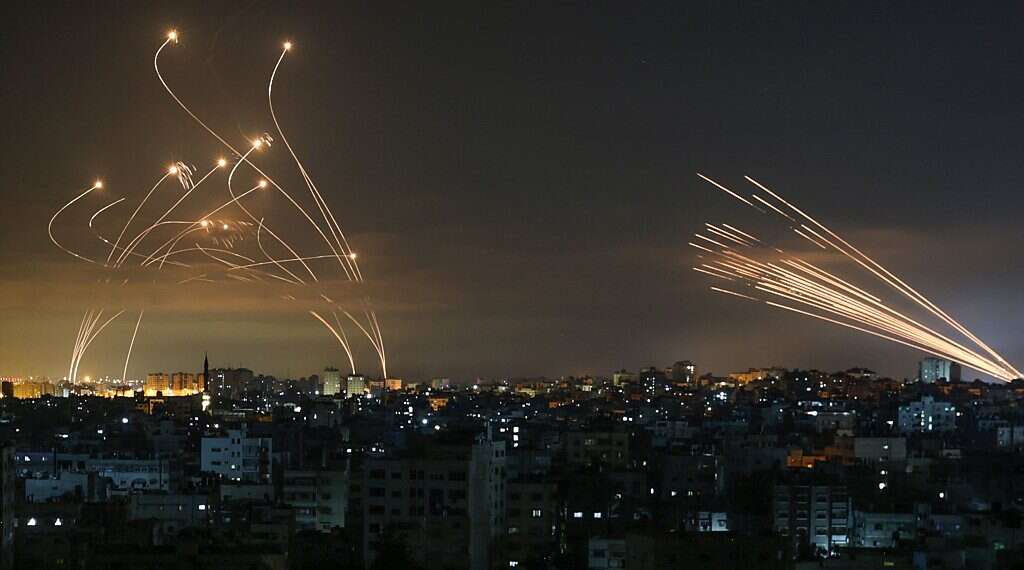 Iron Dome missile defence system (left) intercepts rocket fire from Gaza (right) over southern Israel, May 14, 2021 Hundreds of rockets pound southern Israel as IDF warns it has top Hamas leaders in its sights
