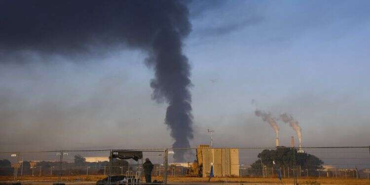 Smoke rises from an oil tank on fire after it was hit by a rocket from the Gaza Strip, near Ashkelon, Israel, Wednesday, May 12, 2021 Huge fire at petroleum facility caused by rocket hit nearly out