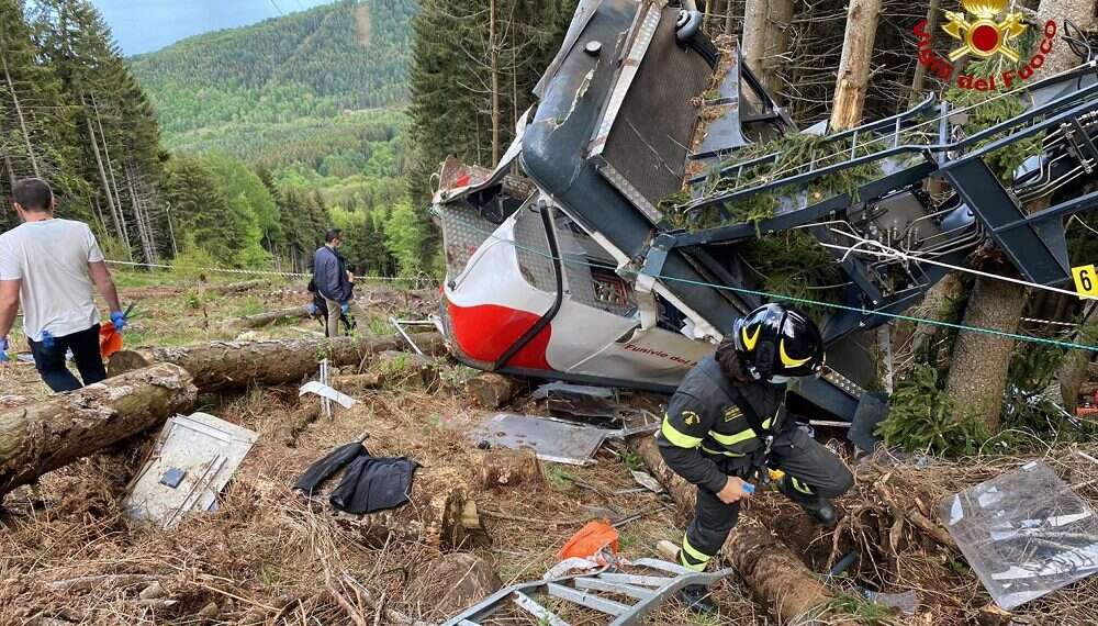 Rescuers work by the wreckage of the cable car that collapsed near the summit of the Stresa-Mottarone line in the Piedmont region, northern Italy, Sunday, May 23, 2021, killing 14 people 5 Israelis killed in cable car crash in Italy, 1 child in critical condition