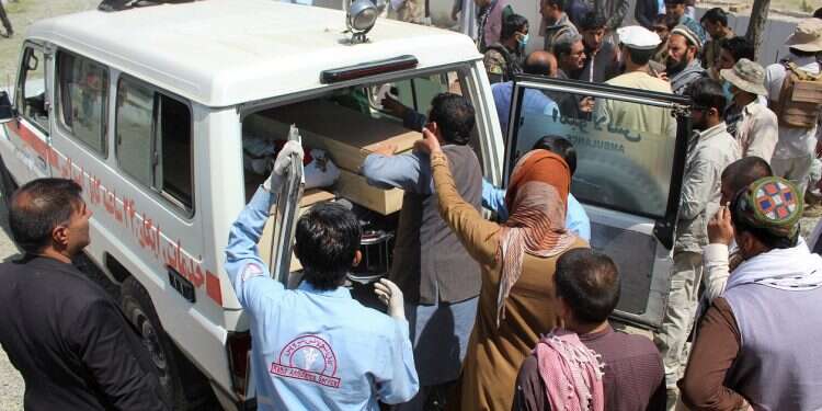 Afghan men transfer a coffin of a victim of this weekend's car bomb blast in the ambulance, in Logar province, Afghanistan May 1, 2021 Car bomb kills 27 in eastern Afghanistan