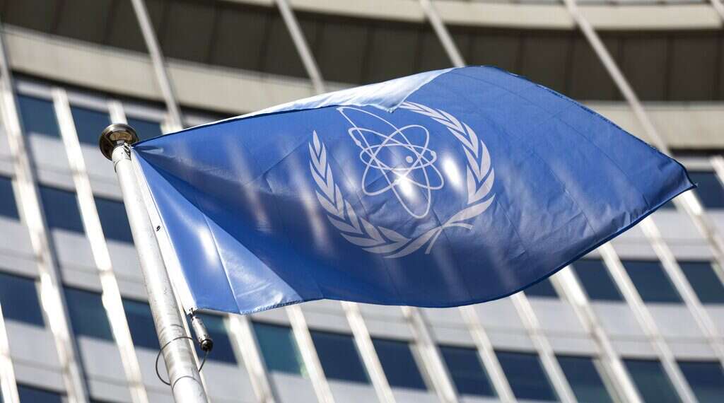 The flag of the International Atomic Energy Agency waves at the entrance of the Vienna International Center in Vienna, Austria US warns Iran: Messing with IAEA oversight puts deal at risk